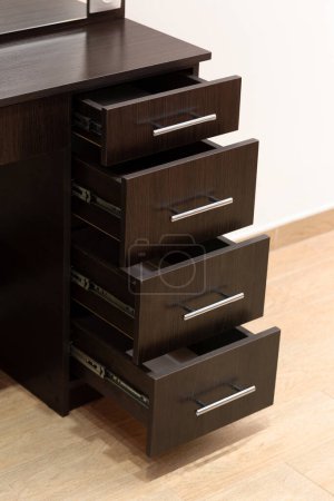 Photo for Close-up of part of a black dressing table with an open drawer. Makeup artist workplace, dressing room, modern dressing table. - Royalty Free Image