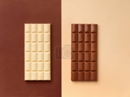Photo for White chocolate bar on a brown background, dark chocolate bar on a light background, top view, chocolate on contrasting backgrounds, space for text. - Royalty Free Image