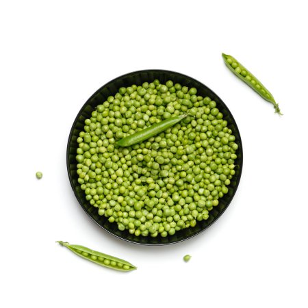 Photo for Peeled grains of fresh green peas in a round black plate and green pea pods on a white background, top view. Vegetable protein, healthy products. - Royalty Free Image