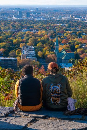 Photo for Montreal, CA - 10 October 2022: People looking at the view over Montreal city from Outremont lookout in Autumn - Royalty Free Image