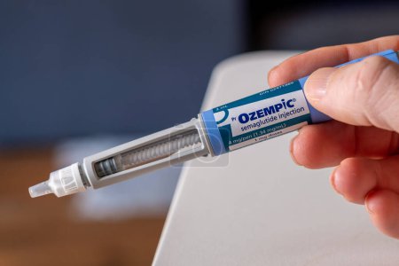 Photo for Montreal, CA - 25 November 2023: Hand holding Ozempic semaglutide injection pen. Ozempic is a medication for obesity - Royalty Free Image