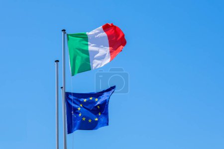 Italian Flag ans Europe Flag waving in the sky in Manarola