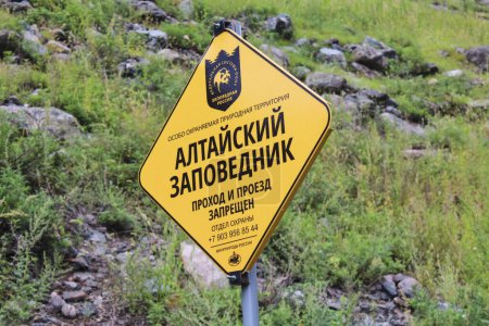 Text on the yellow sign in Russian: Specially protected area. Altai Reserve. Passage and passage is prohibited.