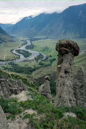 Picturesque green River Valley. Summertime natural landscape, mountains in the clouds, best recreation areas with amazing view. Altai Republic, Siberia, Russia. Vertical photo