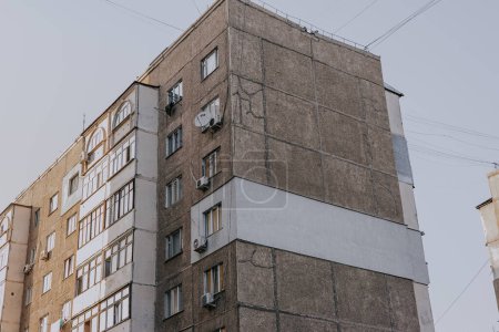 Multi-storey panel house in Kyrgyzstan. Old Panels building in Kyrgyz republic, Soviet architecture house with external insulation for a corner apartment. 