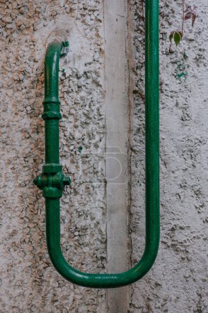 Téléchargez les photos : Ancien tuyau de gaz vert incurvé entre dans la maison à proximité. Gazéification des régions - en image libre de droit