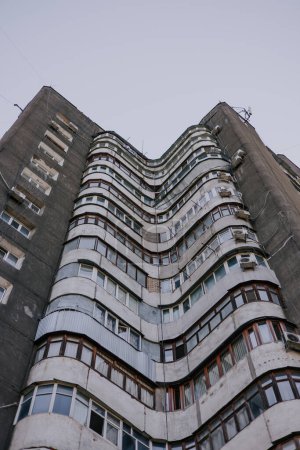 Wavy Soviet multi-storey residential building with round balconies wave shapes. City architecture of the CIS countries, bottom view