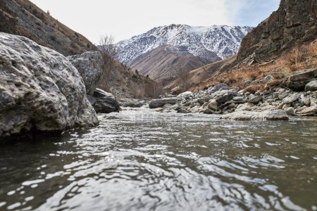 Calm water flow in a mountain river. Off season Natural landscape in Kyrgyz republic, Kyrgyzstan nature