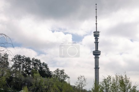 TV tower against the background of a cloudy sky. Koktobe Television and radio broadcast tower in Almaty, Kazakhstan. The citys attractions, park