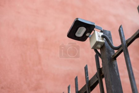 Photo for Small LED street lamp connected to residential building communications. Black flashlight with twelve diodes fixed to a metal fence outside. - Royalty Free Image