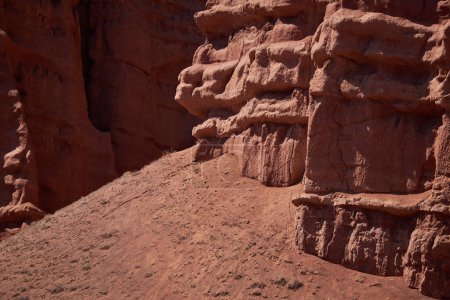 Rocky columns of red sandstone in canyon, aeolian deposits, result of soil erosion. weathering and washing away of rock. geology background