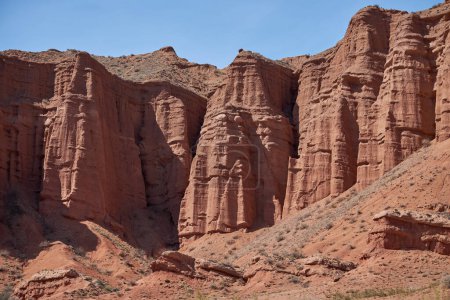 Konorchek canyon, sheer cliffs subject to erosion, travel destination, famous landmark Kyrgyzstan, Central Asia. Rock formation, natural landscape, hiking trekking area, sandstone red rocks