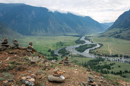 Picturesque green River Valley. Summertime natural landscape, mountains in the clouds, best recreation areas with amazing view. Altai Republic, Siberia, Russia.
