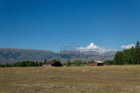 An old village against the backdrop of low mountains in the altai republic. 