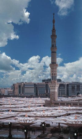 Photo for Top birds eye view of minaret of masjid Al Nabawi mosque minaret and canopy umbrella shades in Madinah, Saudi Arabia. - Royalty Free Image