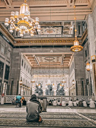 Photo for MECCA, KINGDOM OF SAUDI ARABIA-JUNE 2, 2023: An unidentified man makes supplication at the new King Abdullah extension in Makkah, Saudi Arabia. The new extension expected to cost USD30 billion. - Royalty Free Image