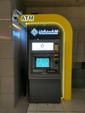Photo for MECCA, KINGDOM OF SAUDI ARABIA-JUNE 4, 2023: The Saudi Investment Bank automated teller machine (ATM) kiosk at Abraj Al Bait tower in Makkah, Saudi Arabia. - Royalty Free Image