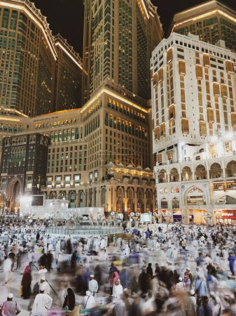 Photo for Slow shutter motion blur of Muslim hajj pilgrims exit Al Haram mosque after evening prayers in Makkah, Saudi Arabia. - Royalty Free Image