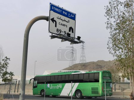 Photo for JUNE 26, 2023-PLAIN OF ARAFAT, MINA, SAUDI ARABIA : Specially chartered bus transport Muslim hajj pilgrims to their camps at Plain of Arafat in Mina, Mecca, Kingdom of Saudi Arabia. - Royalty Free Image