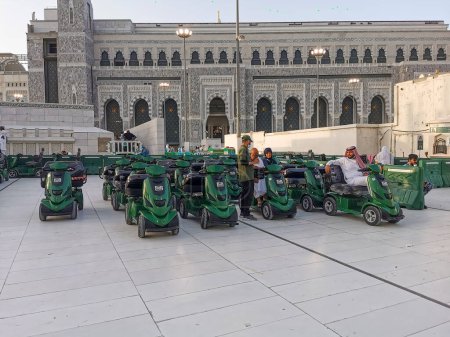 Photo for MECCA, KINGDOM OF SAUDI ARABIA (KSA) - 12 JUNE, 2023 : Environmental friendly battery-operated golf buggy carts for pilgrims rental outside Al Haram Mosque in Makkah, Saudi Arabia. - Royalty Free Image