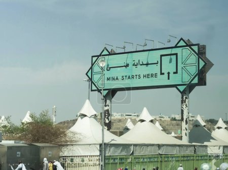 Photo for MINA, KINDOM OF SAUDI ARABIA (KSA) - JUNE 30, 2023 : Huge Mina Starts Here signboard depicting the beginning of Mina plain area for hajj pilgrims to perform the hajj. - Royalty Free Image