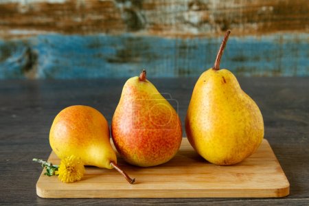 Raw yellow ripe pears on a farm table, still life