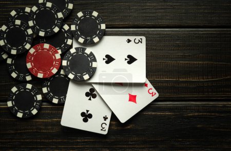 Foto de Successful win with three aces playing cards. Poker game with three of a kind or set combination on vintage black table. - Imagen libre de derechos
