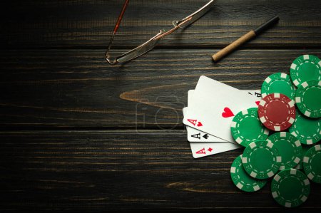 Foto de Jugar a las cartas con una combinación ganadora de tres de una clase o en una mesa vintage negra en un club de póquer. Ganar en deportes depende de la suerte - Imagen libre de derechos
