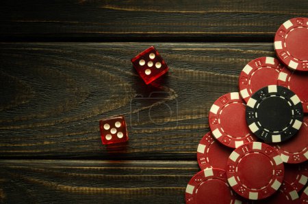 Photo for Poker dice on a black vintage table and chips from winnings. Free space for advertising. Gambling in craps. - Royalty Free Image