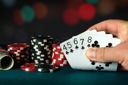 Photo for Poker cards with straight flush combination. The player hand holds a winning combination in a game in a poker club. The concept of luck in the poker game. - Royalty Free Image