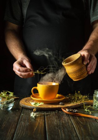 Aus trockenen Heilkräutern gesunden grünen Tee herstellen. Trockenes Mutterkraut in einen Becher mit kochendem Wasser geben. Schulmedizinisches Konzept.