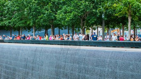 Photo for People at Ground Zero Memorial Manhattan for September 11 Terrorist Attack with Engraved Names of Victims. Patriot Day - New York NY USA 2023-07-30. - Royalty Free Image