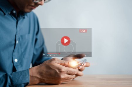 Photo for Man touching smartphone to starting live streaming and watching screen for video streaming on internet and multimedia, social technology, social Media, lifestyle with technology. - Royalty Free Image