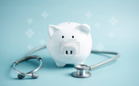 Photo for Piggy bank with stethoscope. money health check concept. Health care financial checkup and saving for medical insurance cost planning in the future. - Royalty Free Image