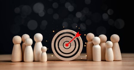 target and goal concept, Wooden figures standing around dartboard and arrow for creative and set up business objective target goal, marketing solution, target for business investment.