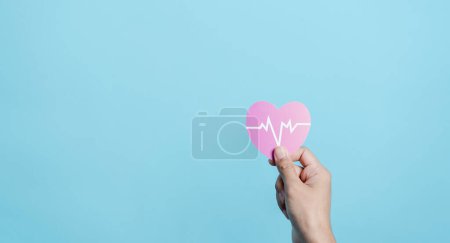 Hand holding red heart donation with pulse cardiogram, health care, organ donation, family life insurance, world heart day, world health day, praying concept