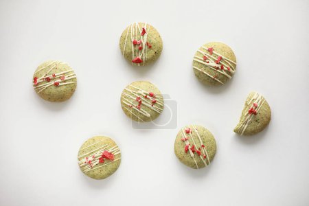 Composition with homemade mint gingerbread cookies with matcha and decorated sublimated strawberries and vanilla cream isolated on white background. Sugar, gluten and lactose free and vegan
