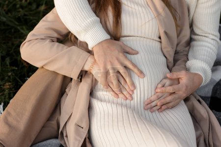 Photo for Family day. Stylish unrecognisable marriage pregnant couple waiting for baby. Man is hugging and touching woman belly outdoors. World IVF Day. Pregnancy, parenthood, motherhood, love, family concept - Royalty Free Image