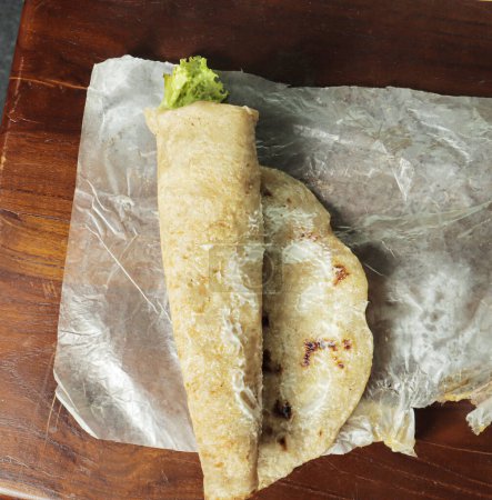 Shawarma con repollo en una bandeja de madera.
