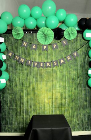 Photo for Party decoration with green balloons and green ribbons on a green background - Royalty Free Image