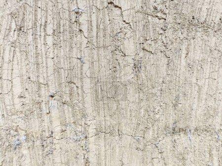 Photo for Dry cracked plaster texture with vertical striations and random crack patterns - Royalty Free Image