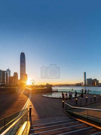 Photo for Promenade and skyline of Hong Kong city under sunset - Royalty Free Image