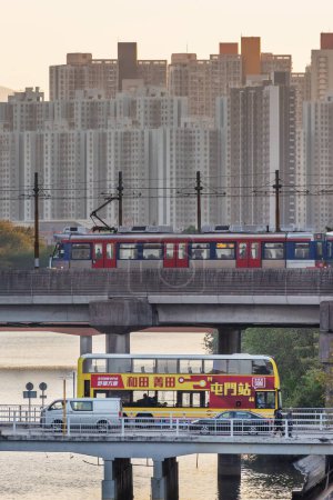 Téléchargez les photos : Hong Kong, China - December 25 2022 : Light rail transit in Tuen Mun. LRT is a light rail system operated by MTR Corporation, serving Tuen Mun, Yuen Long and Tin Shui Wai in Hong Kong city - en image libre de droit
