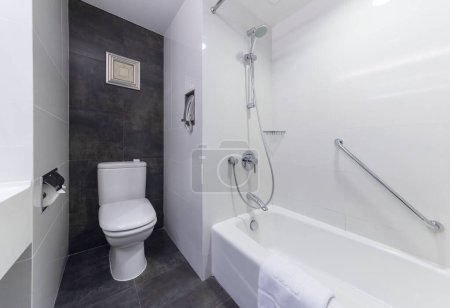 Photo for Renovated bathroom with toilet, shower tub, and sink - Royalty Free Image