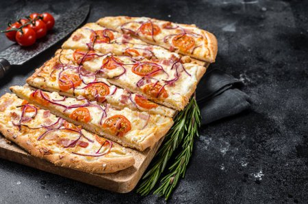 Foto de Homemade Flammkuchen or tarte flambee with cream cheese, bacon, tomato and onions. Black background. Top view. Copy space. - Imagen libre de derechos