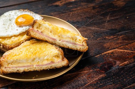 Photo for French toasts Croque monsieur and croque madame, grilled sandwiches on brioch bread with sliced ham, melted emmental cheese and egg. Wooden background. Top view. Copy space. - Royalty Free Image