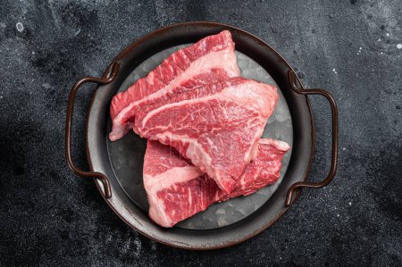 Foto de Raw Silverside sirloin beef steak cut on butcher tray. Black background. Top view. - Imagen libre de derechos
