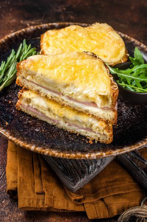Photo for Croque Monsieur toasted sandwich with Cheese, Ham, Gruyere and Bechamel Sauce. Dark background. Top view. - Royalty Free Image