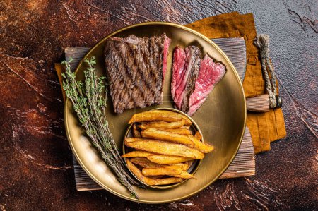 Photo for Elk steak with herbs and french fry, game meat. Dark background. Top view. - Royalty Free Image