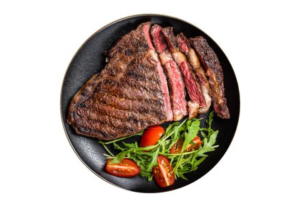 Barbecue grilled and sliced wagyu Rib Eye beef meat steak on a plate. Isolated on white background